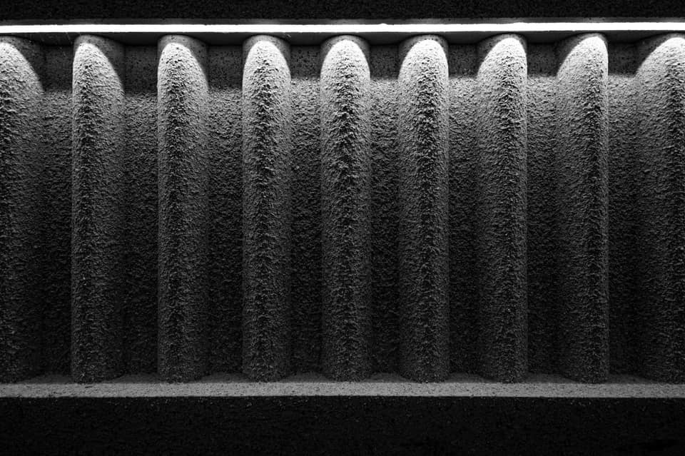 Close-up of the dust-coated pleats of a used air filter
